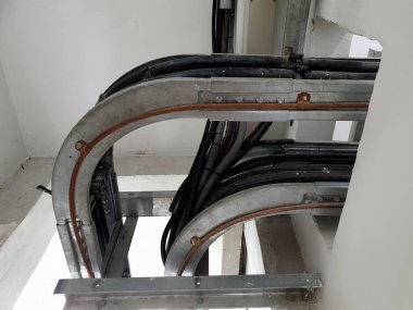 Cable tray installation between the first and second floors in electrical substation. clipart