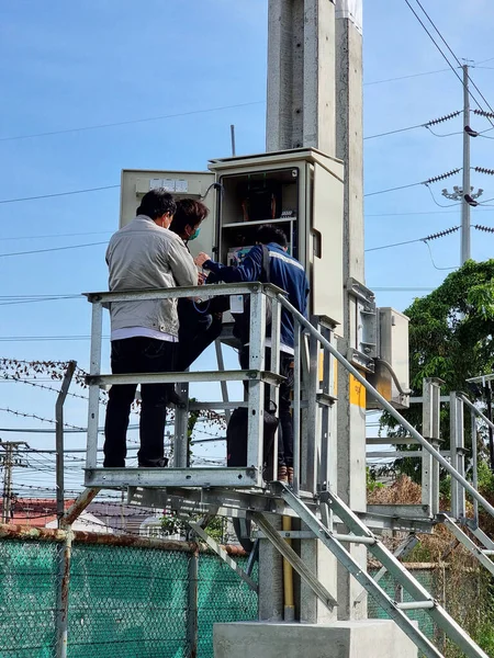The electrical engineer checks communication for the operation of the 115kV Load Break Switch control cubicle.