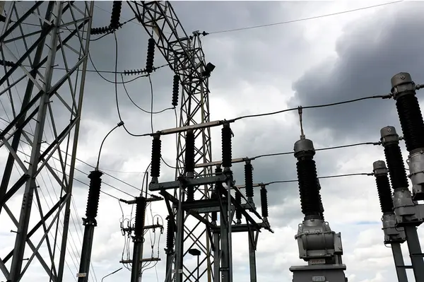 115kV Take-off structure and high voltage equipment in substation such as Lightning arrester,  Disconnecting switch, Voltage transformer, Current transformer on nimbus clouds in the sky background