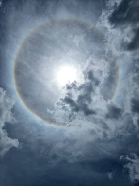 The sun halo with cloud in the sky on midday.
