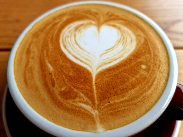 Sideway shop coffee, close-up hot latte art coffee background.