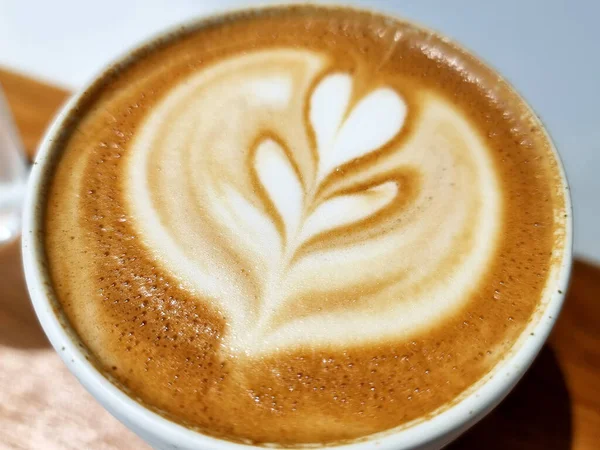 Sideway shop coffee, close-up hot latte art coffee background.