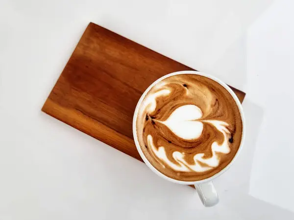 Sideway shop coffee, Top view a cup of hot latte art coffee on wooden plate