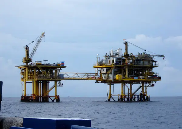 The perspective of a remote offshore oil and gas platform from a boat of offshore marine service