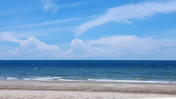 Sea, and blue sky with clouds and waves on the beach along the coast of the Gulf of Thailand.