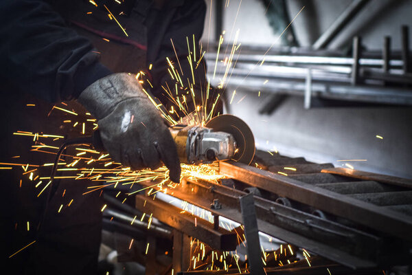 Laser metall cut cnc machine. Fly fire sparks background in the industrial workshop, near Kocani, Macedonia