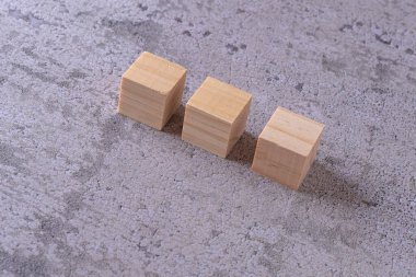 Beton bir yüzeyde üç tahta küp