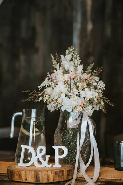 a bouquet of flowers and a cup of tea on a wooden table