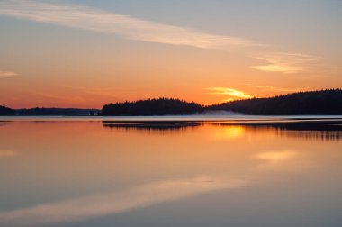 Yaz başında, Finlandiya 'da sakin bir gölün kenarında, sudan yükselen sisli bir havada.