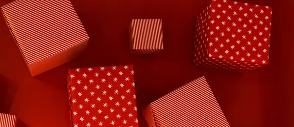 banner gift boxes of different sizes on a red background top view