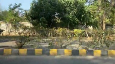 16 Mart 2024 'te Lahor Pakistan' da kişisel araba yolculuğu sırasında Kasur karayolu trafiği ve pazarı manzarası.