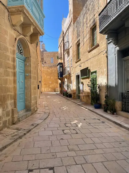 Historic village alley with ancient architecture and charming Maltese buildings.