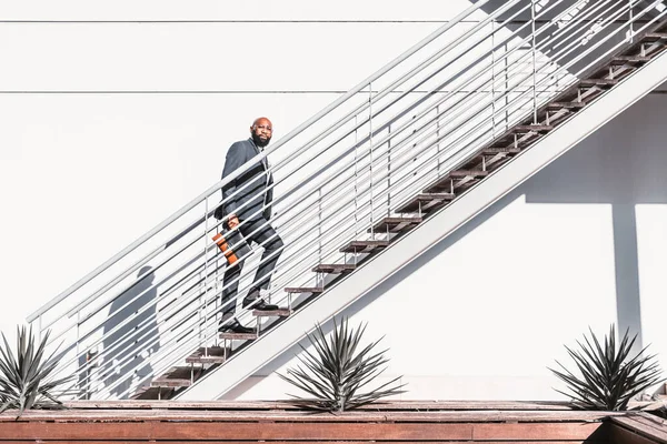 Black Bearded Businessman Climbs White Metallic Staircase Sunlight Wearing Suit — Stock fotografie