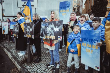Lisbon, Portugal - February 24, 2023: On the sidewalk, women and their children calling for peace and an end to the war that has disrupted lives marking one year since the conflict in Ukraine began