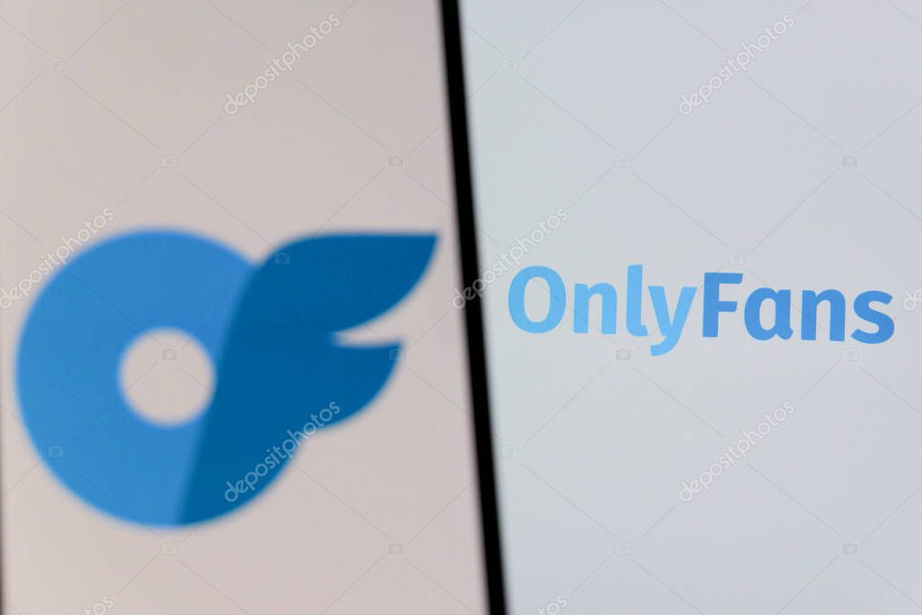 Bandung, Indonesia - August 12, 2025: In this photo illustration, The OnlyFans logo displays on a mobile phone with OnlyFans logo in the background.