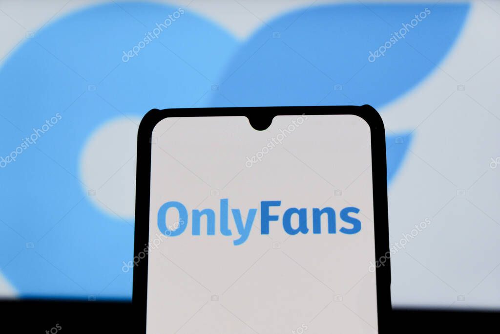 Bandung, Indonesia - August 12, 2025: In this photo illustration, The OnlyFans logo displays on a mobile phone with OnlyFans logo in the background.