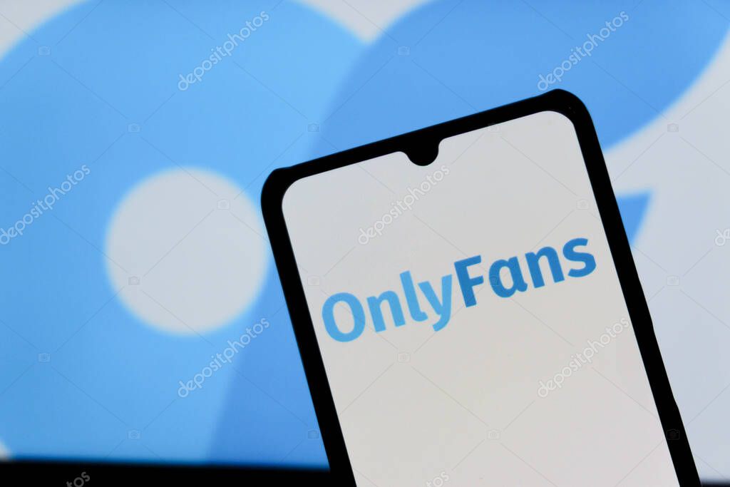 Bandung, Indonesia - August 12, 2025: In this photo illustration, The OnlyFans logo displays on a mobile phone with OnlyFans logo in the background.
