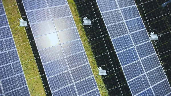 Solar panels on green meadow with digital lines and energy collection symbols. Aerial drone view solar green energy generation farm