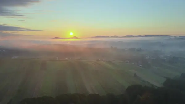 Beautiful misty morning sunrise over countryside. Aerial