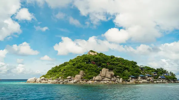 It is famous for its diving spots and its great snorkelling beach. Wooden bridge, no people. Scenic view tropical paradise with peaceful resort, rocky coastline, clear turquoise sea with coral reef against cloud sky. Koh Nangyuan Near Koh Tao Island,