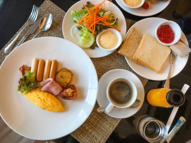 Table full of various fresh food in luxury modern restaurant. Delicious dishes, cold cuts, salmon, omelette, pastries, juices, cheese. Delicious and lavish breakfast or morning meal in high-end hotel