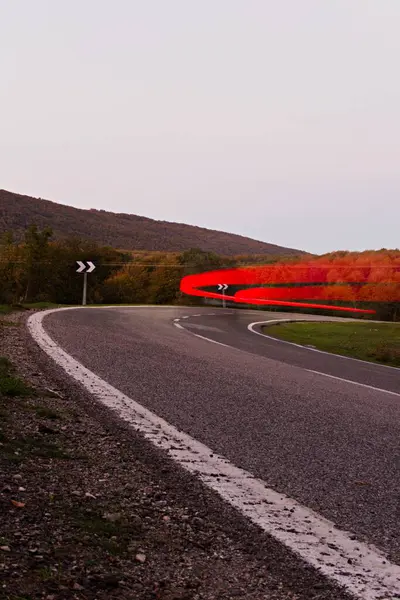 Time lapse traffic auto. time lapse car in mountain pass, passing through a road curve at sunset in Spain. high quality photo