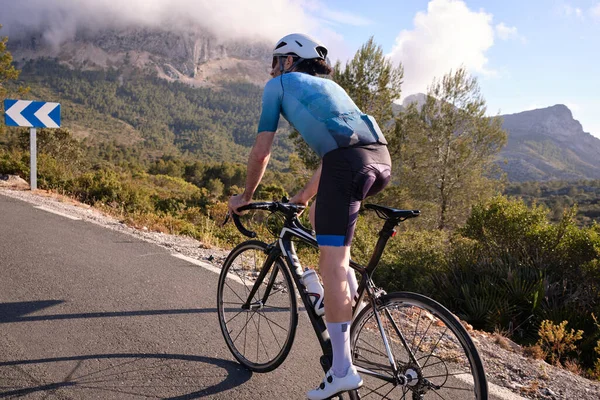 Cyclist training on road bike in mountain.Sport motivation.Cycling holiday in Spain.