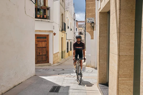 Professional cyclist riding in the old town of Javea, Spain.Cycling holiday in Spain.Alicante region.