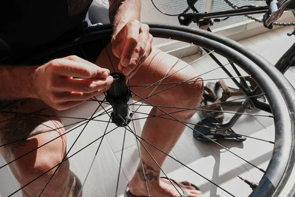 A bicycle mechanic repairs a wheel. Close-up photo.Bicycle repair at home.
