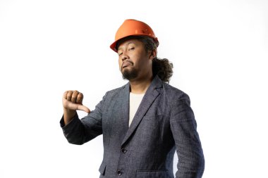 Proje lideri, turuncu takım elbiseli ve beyaz arka planda miğferi olan dostça Asyalı bir adama hoşnutsuzluk ya da güvensizlik jesti yapıyor. inşaat ya da madencilik konsepti fotoğrafı