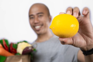 asian man indonesia bring lemons clipart