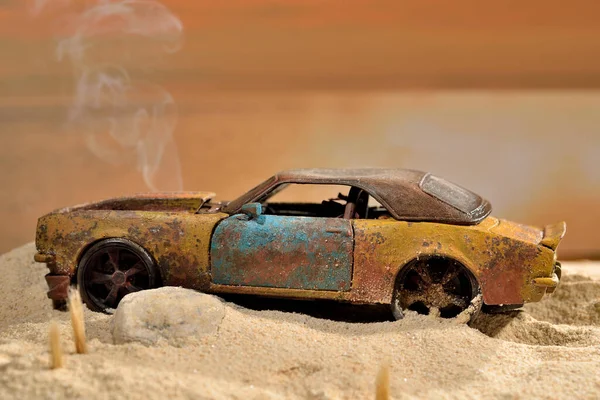 mockup of toy sports car stuck in beach sand with smoke from engine
