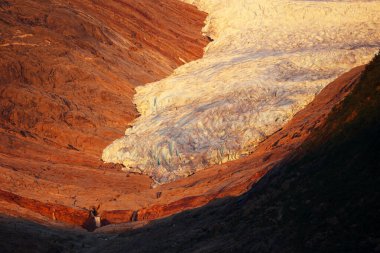 Svartisen glacier at sunset in Holandsfjord, Norway   clipart