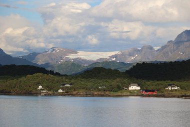 Fantastic Norwegian coastal landscape with the Svartisen glacier in the background   clipart