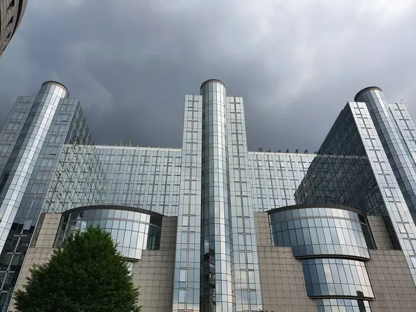 Brüksel 'deki Avrupa Parlamentosu binası. Kara bulutları tehdit eden camdan pencereler. Haziran 2021.