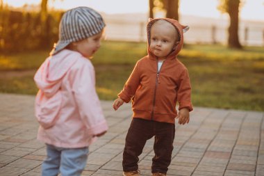 Sonbahar parkında küçük tatlı bir kız ve erkek.