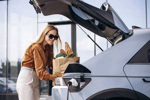 Woman Food Shopping Bags Charging Electric Car — Stock Photo, Image