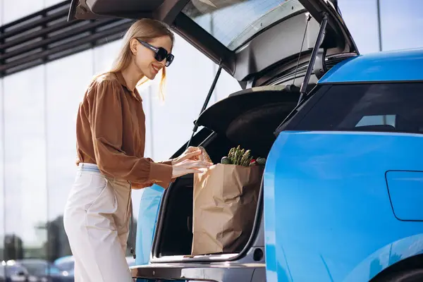 Woman Grocery Paper Bag Her Electric Car — Stock Photo, Image