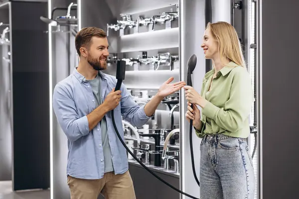 Couple choosing shower at the building market