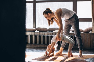 Mother and daughter yoga at home