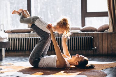 Mother and daughter yoga at home