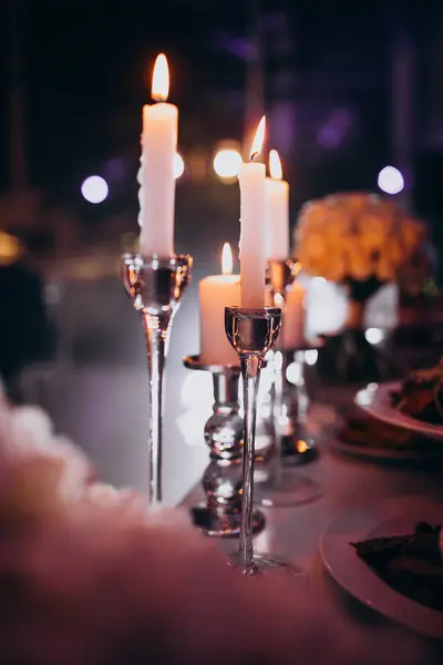 Lit candles at a wedding decorated restaurant