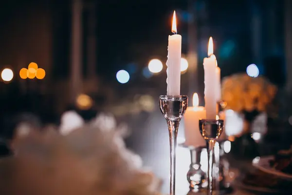Lit candles at a wedding decorated restaurant