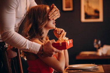 Lokantada sevgililer gününde hediye kutusu veren adam.