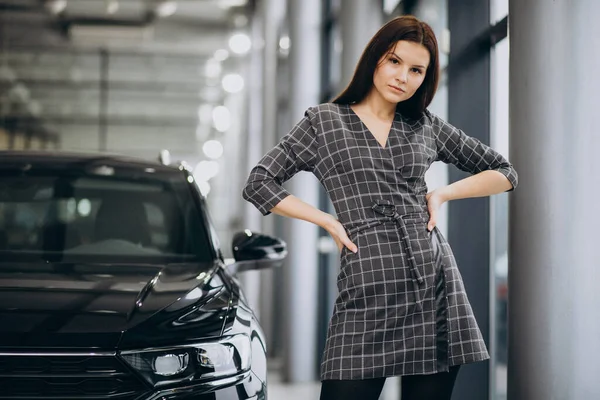 Młoda Kobieta Salonie Samochodowym Wybiera Samochód — Zdjęcie stockowe