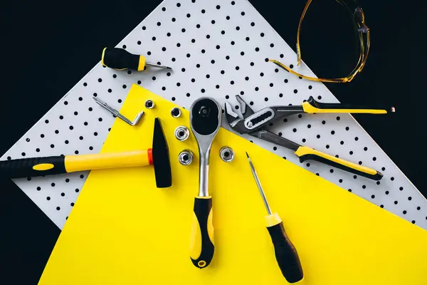 Yellow set of tools on black and yellow background