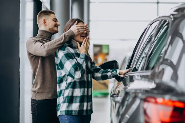 Young Man Presents Mcar His Girlfriend Car Showroom — Stock Photo, Image