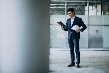 Binada sağlam şapkalı yakışıklı bir mühendis.
