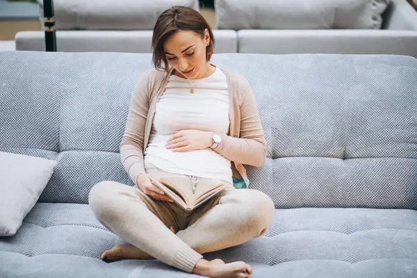 Joven Embarazada Leyendo Libro Casa —  Fotos de Stock