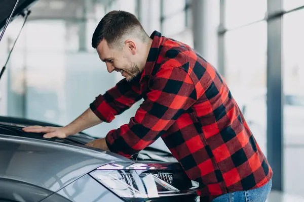 Young man making diagnostics of the vehicle